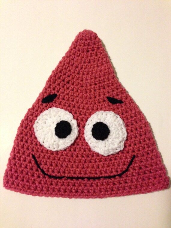 a red crocheted hat with eyes on it