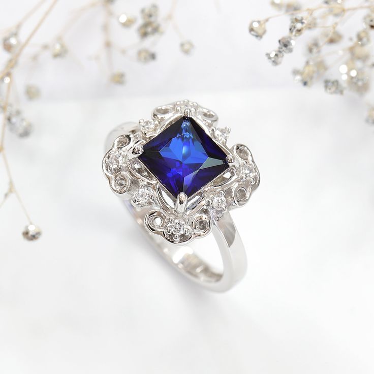 This beautiful Sterling Silver 1.75 carat Princess Simulated Blue Sapphire CZ Wedding Engagement Ring ( Size 5 to 9 ) by DoubleAccent is meticulously crafted in gleaming and durable Sterling Silver. Our stones are the highest quality diamond simulant that are polished, finely cut, loupe clean, and have an exactly similar appearance and as beautiful as to naturally occurring diamonds. All cubic zirconia stone weights are approximate and listed as diamond equivalent weight in carats. Our client's Elegant Royal Blue Sapphire Ring With Center Stone, Elegant Royal Blue Brilliant Cut Rings, Elegant Sapphire Halo Ring With Cubic Zirconia, Exquisite Blue Diamond Ring For Gift, Exquisite Blue Diamond Ring Gift, Blue Lab-created Sapphire Diamond Ring For Promise, Blue Cubic Zirconia Promise Ring, Elegant Royal Blue Gemstone Rings, Brilliant Cut Sapphire Birthstone Ring In Cubic Zirconia