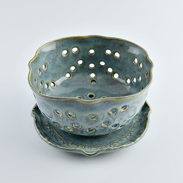 a blue bowl and saucer sitting on top of each other