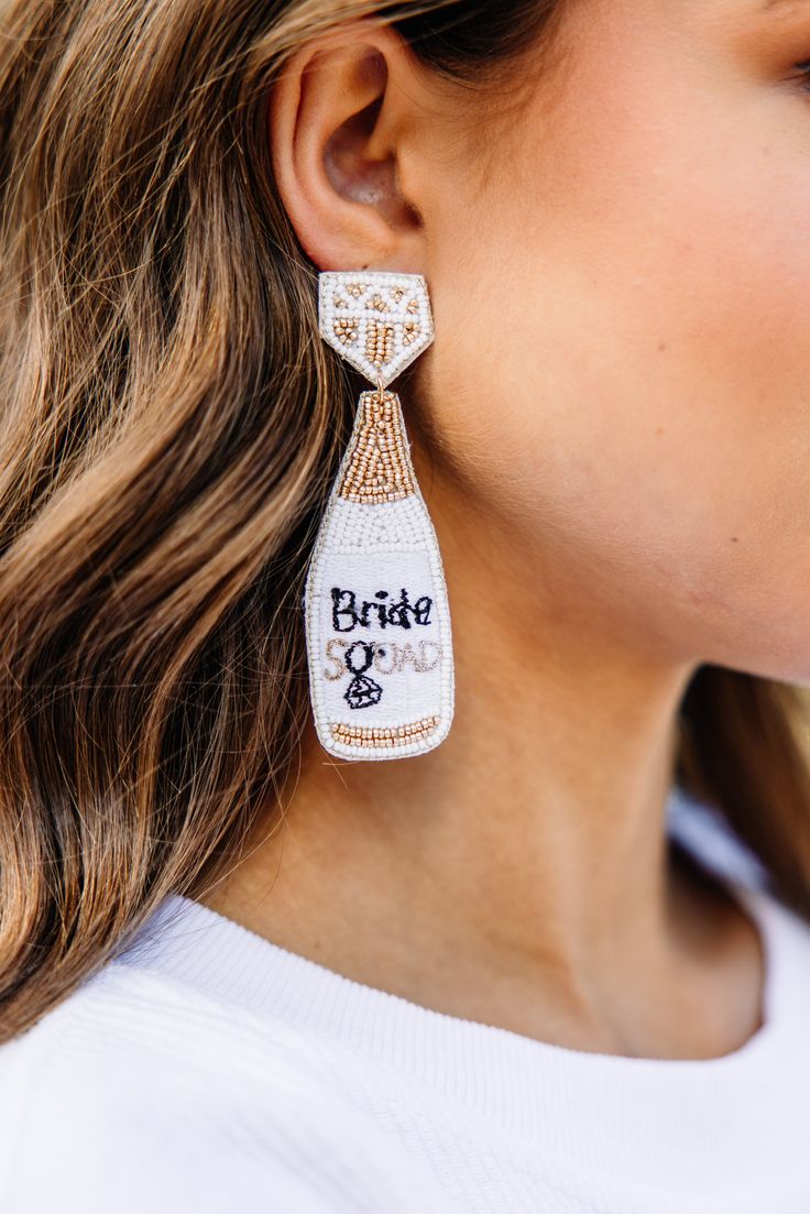 You are the bride and that calls for bubbles! These earrings are so perfect for any bride to be! They are so cute and we love how light they are as well! These fun earrings are sure to complete any bridal shower or bachelorette party look! Glamorous White Bridal Earrings For Wedding, White Glamorous Chandelier Earrings For Party, White Bridal Jewelry With Matching Earrings, White Dangle Jewelry For The Bride, White Dangle Jewelry For Bride, Bridal Beaded Dangle Earrings For Wedding, Beaded Dangle Bridal Earrings For Wedding, White Dangle Bridal Earrings, Beaded Dangle Earrings For Wedding