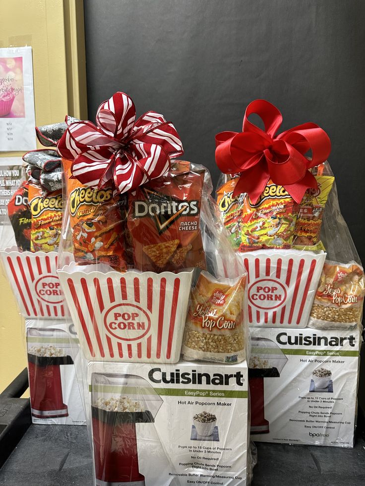 some bags of food are sitting on a table with a red bow around the top