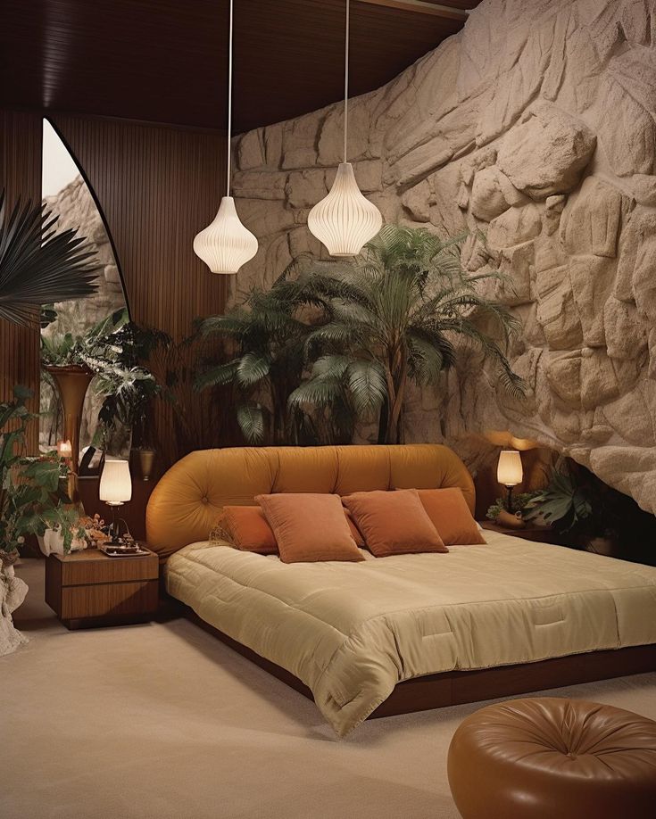 a large bed sitting in a bedroom next to two lamps and a plant on the wall