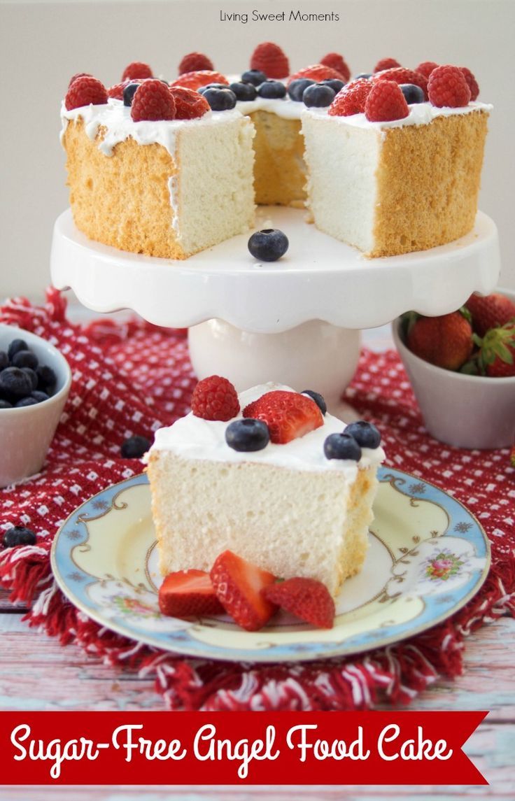 a slice of cake on a plate with strawberries and blueberries in the middle