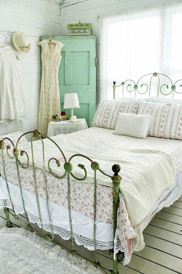 a bedroom with white walls and wooden floors