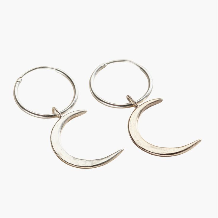 These lunar-inspired Crescent Moon Charm Hoop Earrings add a touch of celestial beauty suitable for both everyday and occasional wear. The crescent shapes evoke mystical and romantic associations often linked with the moon, such as cycles, intuition, and feminine energy. Handmade by our jewellers in Sterling Silver. We make our jewellery using the finest quality 925 Sterling Silver. Silver Crescent Minimalist Hoop Earrings, Silver Crescent Cartilage Earrings With Moon Charm, Sterling Silver Crescent Cartilage Earrings With Moon Charm, Small Silver Hoop Earrings With Moon Charm, Silver Small Hoop Earrings With Moon Charm, Minimalist Sterling Silver Hoop Earrings With Moon Charm, Minimalist Crescent Hoop Earrings, Nickel-free Moon Shaped Hoop Earrings, Nickel-free Moon-shaped Hoop Earrings