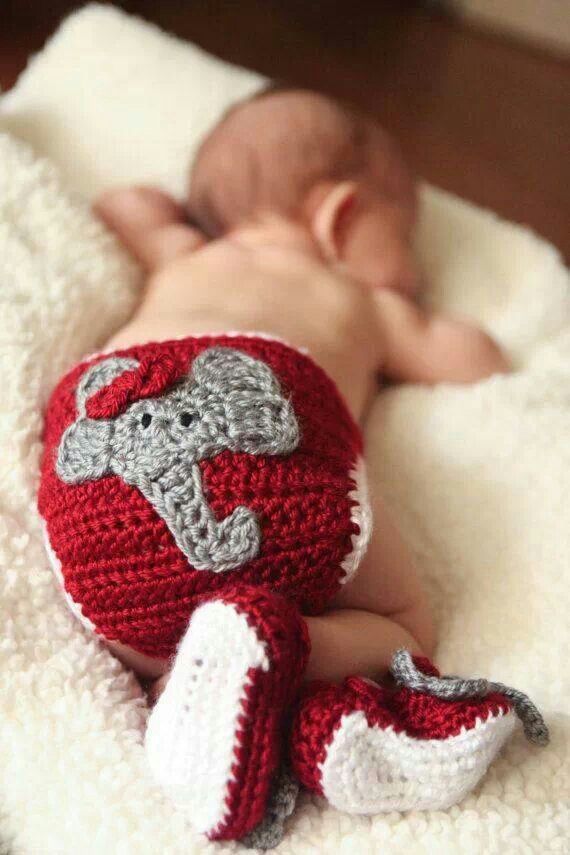 a baby is wearing a crocheted elephant diaper and laying on a blanket