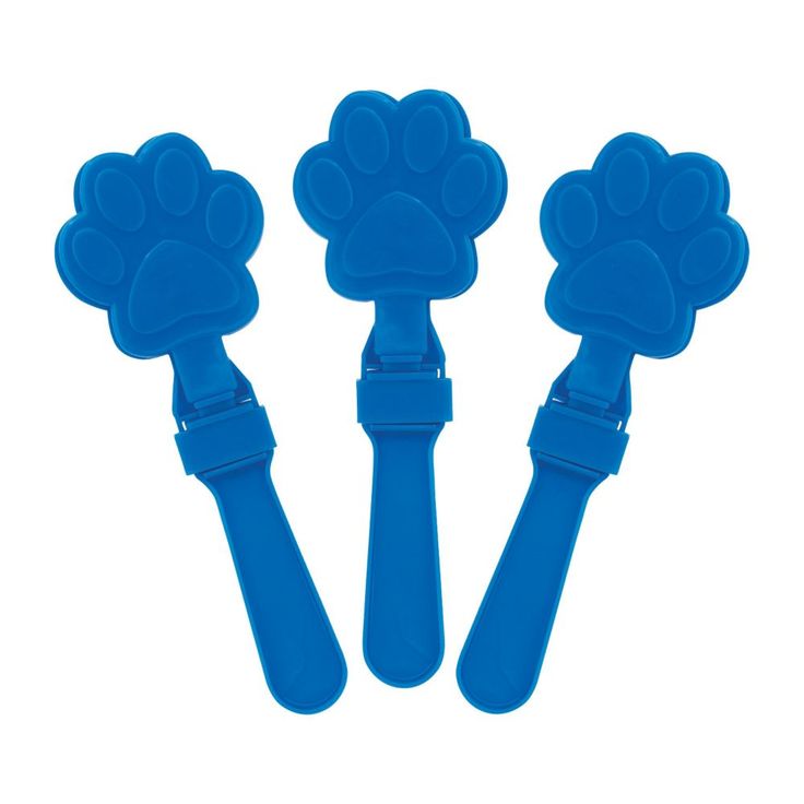 three blue dog paw shaped toothbrushes on a white background with clippings