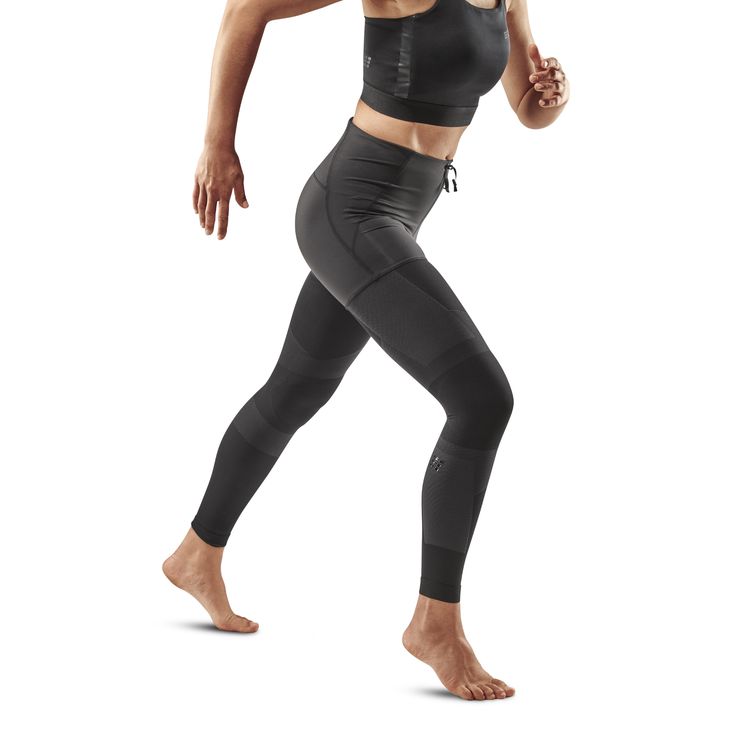 a woman in black sports bra top and leggings with her hand on her hip