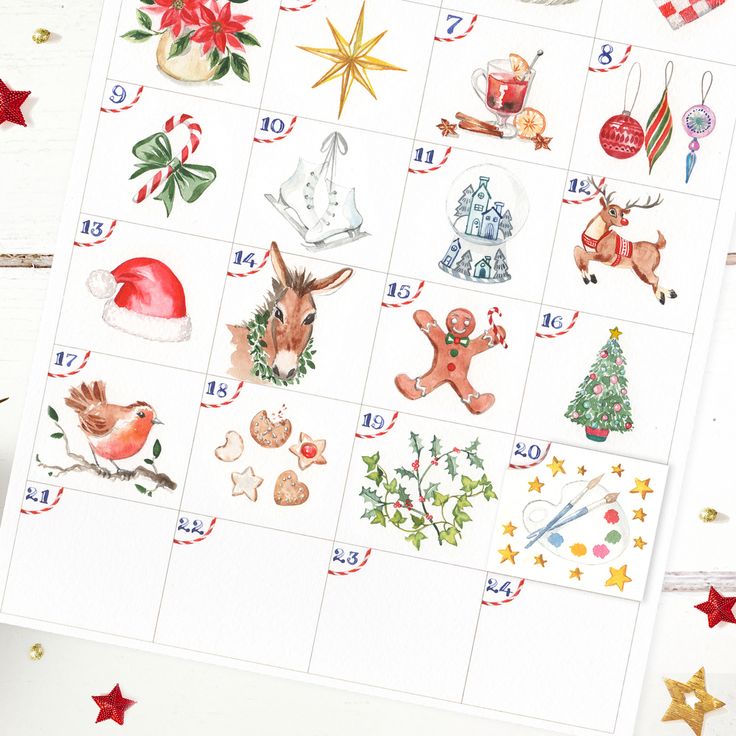 christmas themed stickers on top of a white table with red and gold stars around them