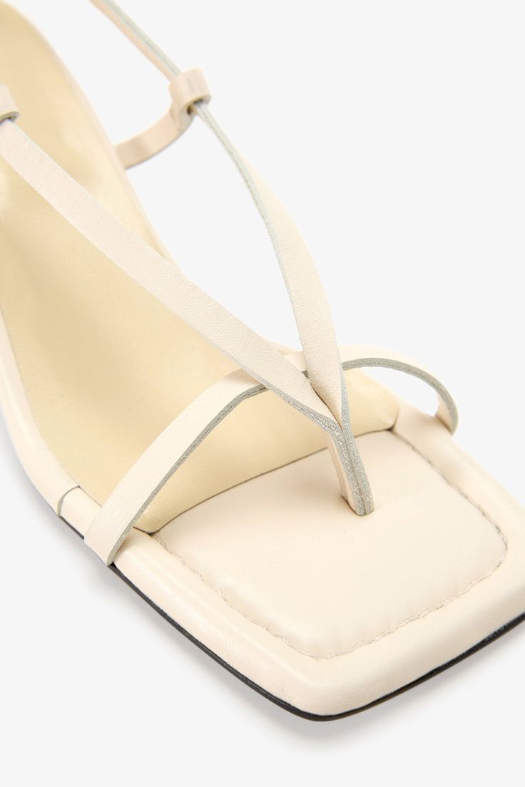 Strappy sophistication. Our Greta Sandals feature a modern square toe and an adjustable slingback strap for a flattering look, enhanced by a chic kitten heel and minimalist raw edges. Whether it's running between meetings or dancing the night away, their padded soles and soft Italian leather let you do it all in comfort—and impeccable style.[SPLIT] Astrid wears Greta in cream, in disco, and in black. Heel height is approximately 2" (5 cm). Sold in US sizes, though please note that shoes may be l Modern Slingback Sandals With Wrapped Heel, Modern Slingback Sandals With Padded Heel, Cream Kitten Heels For Summer, Summer Cream Kitten Heels With Ankle Strap, Cream Ankle Strap Kitten Heels For Summer, Summer Cream Leather Kitten Heels, Cream Sandals With Square Toe For Evening, Evening Sandals With Square Toe In Cream, Cream Slingback Pumps For Summer Evenings