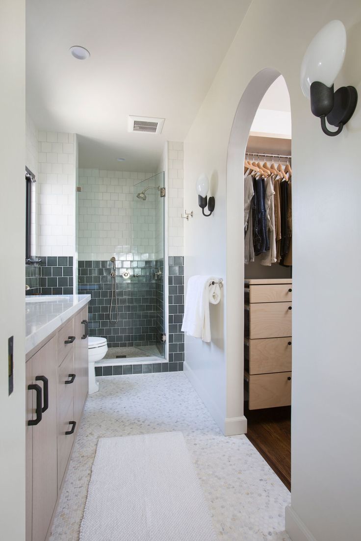 a large bathroom with a walk in shower next to a sink