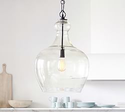 a glass light hanging from a kitchen ceiling