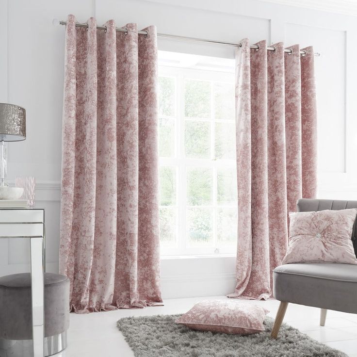 a living room scene with focus on the curtained window and pink floral drapes