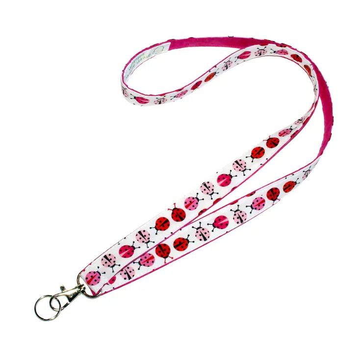 Playful pink and red ladybugs create a charming way to carry your badge or keys. This 3/4 inch wide, 100% cotton strap is white with a colorful row of pink and red ladybugs. The back is a coordinating pink fabric, also in 100% cotton. A metal swivel clip and small key ring complete the construction. Lanyard is durable, attractive and 100% handmade in Minnesota. Pink Ladybug, Keychain Lanyard, Key Fobs Wristlet, Girly Gifts, Writing Gifts, Hold My Hand, Id Badge Holders, Badge Holder, Id Badge