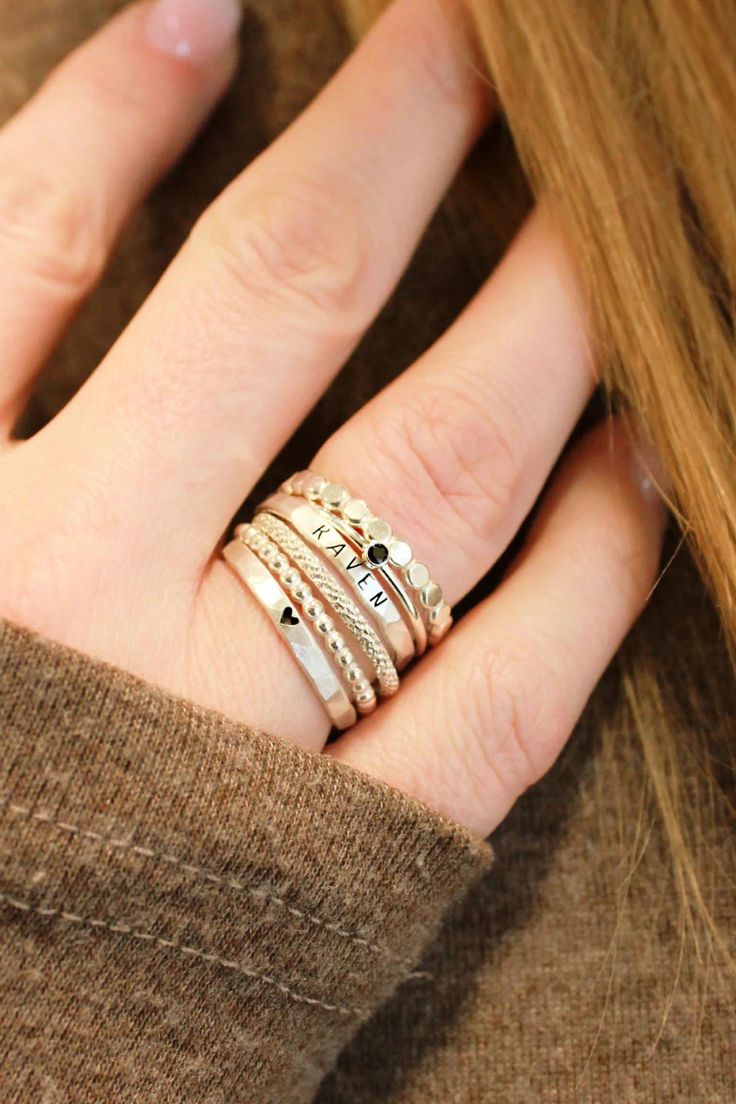 Stunning stacking name rings set, including a personalized name ring and dainty spacer rings. This silver name ring set is a great gift for mom or grandma! Discover our beautiful kids name ring stacks, the perfect sentimental gift for mom's birthday or moms-to-be! These stackable kids name rings are the perfect simple meaningful jewelry pieces to add to your collection. Shop all of our custom personalized jewelry and silver name rings here! Silver Stackable Rings For Mother's Day Promise, Silver 14k Gold Stackable Initial Ring, Elegant Sterling Silver Stackable Initial Ring, Sterling Silver Stackable Initial Ring, Elegant Stackable Sterling Silver Birthstone Ring, Heart Shaped Stackable Rings For Everyday, Sterling Silver Stackable Engraved Ring, Fine Jewelry Sterling Silver Stackable Engraved Ring, Fine Jewelry Engraved Sterling Silver Stackable Ring