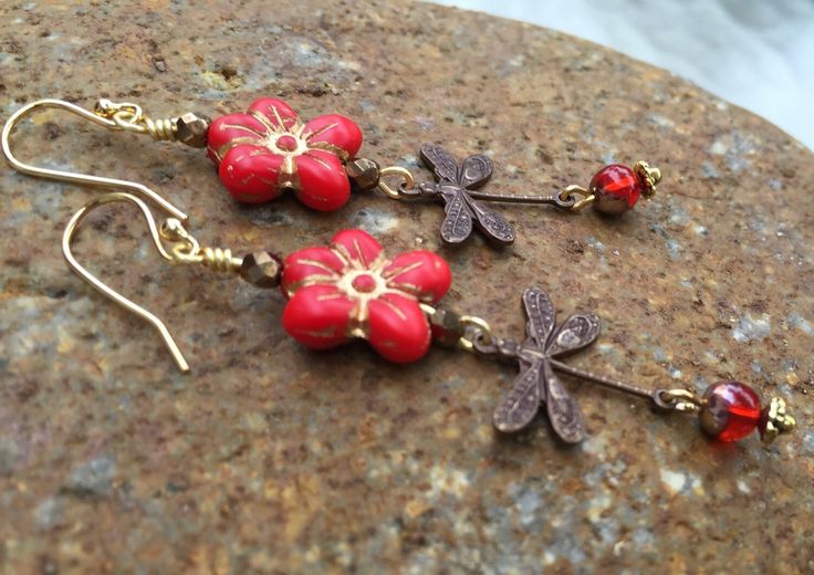 "Adorable orange red Czech glass \"Forget Me Not\" flowers wire wrapped with little translucent red rounds and vintage bronze stamped dragonfly charms. Matte opaque red 13 x 14 mm Czech glass flower has golden bronze Picasso glaze and is wire wrapped in gold plate. Pretty little 5 mm translucent red Czech glass ball with metallic gold finish dangles on the end. Lightweight earrings hang from 14k gold plated ear wires and measure 2 7/8\" long." Handmade Red Flower Earrings With Round Beads, Red Bohemian Soldered Earrings, Vintage Red Copper Earrings, Bohemian Red Soldered Earrings, Adjustable Nickel-free Red Flower Earrings, Nickel-free Red Copper Earrings, Adjustable Red Flower Earrings With Ear Wire, Red Copper Earrings As Gift, Red Copper Earrings Gift