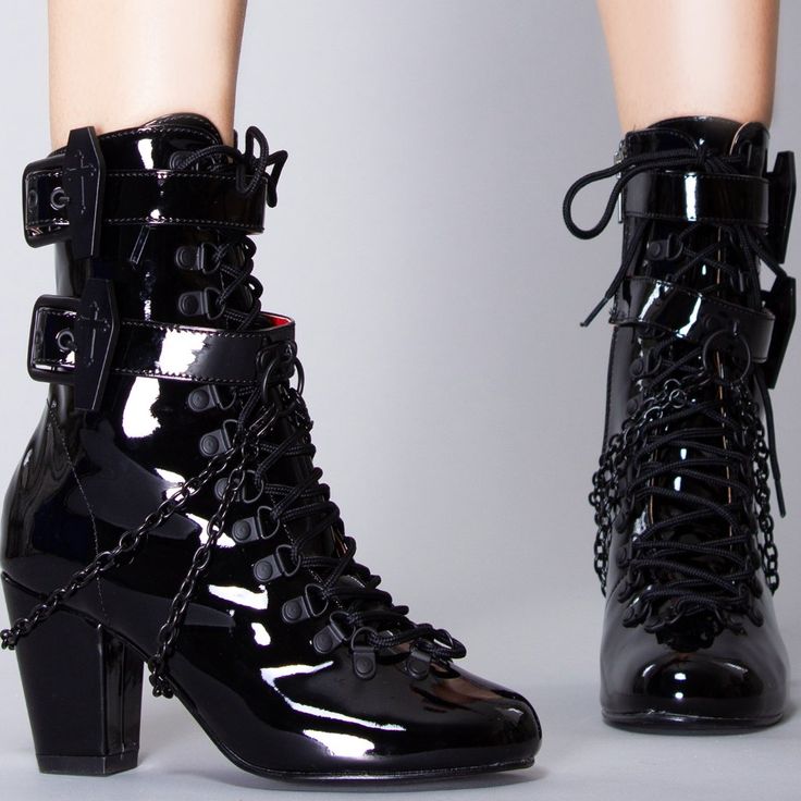 Prepare For Your Descent To The Other Side With The Final Service Ankle Boots From Demonia. These Soul Stealing Festival Boots Feature A Black Vegan Patent Leather Upper With Corset Style Lace Up Front, Double Ankle Straps With Metal Coffin Buckle, Removable Chain Accents, And Interior Zipper Closure. With These Cute Boots You’ll Enter The Afterlife In Style. Final Service Ankle Boots 3"" Block Heel Vegan Patent Leather D-Ring Lace-Up Front Double Coffin Buckle Straps O-Ring Plate And Double Han Black High Heel Punk Combat Boots, Punk Style Black High Heel Combat Boots, Black High Heel Punk Boots, Black Punk Boots With Reinforced Heel, Black Ankle-high Punk Boots, Punk Ankle-high Heeled Boots With Reinforced Heel, Black Punk High Ankle Heeled Boots, Black Ankle-high Combat Boots With Reinforced Heel, Black Punk Style High Ankle Heeled Boots