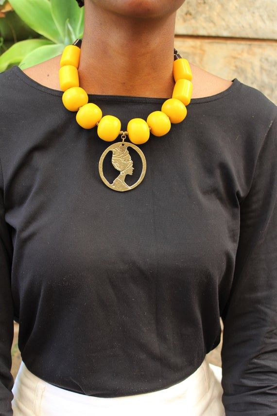 Handmade in Nairobi , Kenya!A beautiful. statement, necklace crafted with african beads, a brass pendant and finished with a brass clasp.***SHIPPINGShipping is done via DHL Express, 3-7 days delivery,Add multiple items to your cart and pay shipping for one item ONLY! Unique Wooden Beaded Necklaces, Gift Beaded Necklaces With Wooden Beads, Gift Wooden Beaded Necklaces, Gift Wooden Beads Necklace, Necklaces With Polished Round Beads, Unique Pendant Beaded Necklace, Gift Jewelry With Large Beads, Wooden Beads Pendant Necklace As Gift, Pendant Necklace With Wooden Beads For Gift