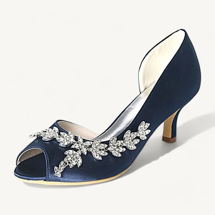 a women's blue shoe with flowers on the heel and heels in satin fabric