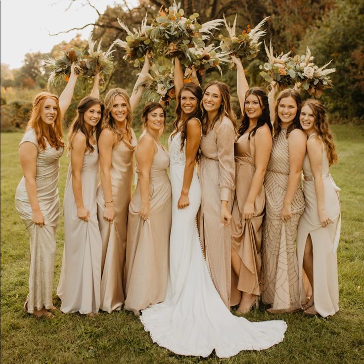 a group of women standing next to each other on top of a lush green field