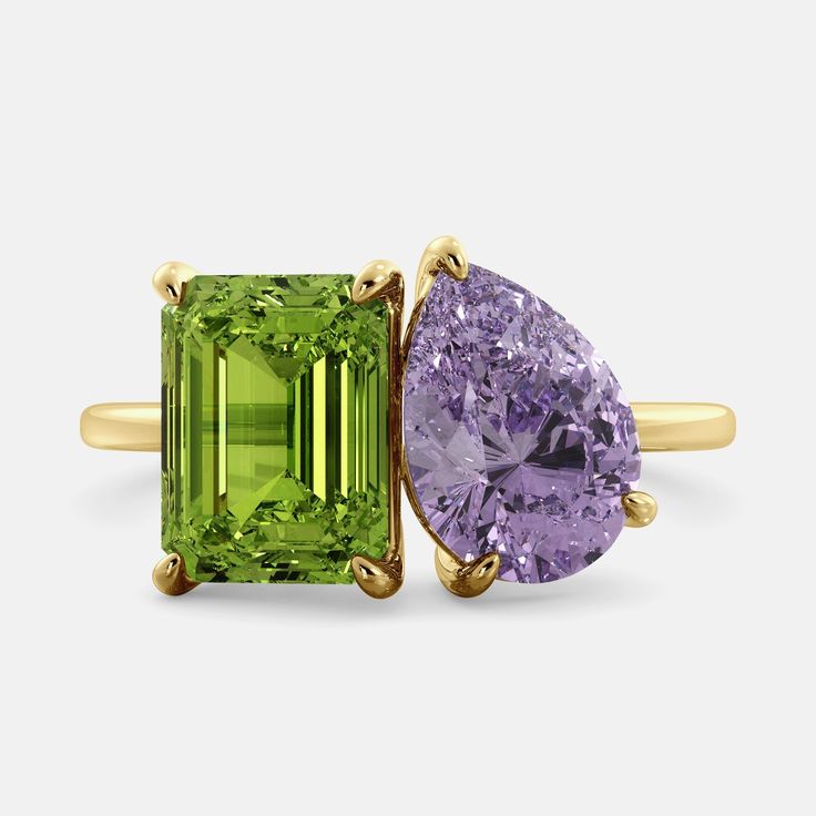 A toi et moi ring with an emerald-cut Green Peridot and a pear-cut gemstone. The emerald-cut morganite is set on the left of the ring Luxury Peridot Birthstone Ring, Modern Green Jewelry With Accent Stones, Elegant Multi-stone Peridot Gemstones, Modern Green Emerald Ring With Accent Stones, Modern Green Jewelry With Gemstone Accents, Fine Jewelry Peridot Gemstones For Formal Occasions, Green Amethyst Ring In 14k Gold, Green Amethyst Ring For Formal Occasions, Lime Green Gemstone Ring Jewelry