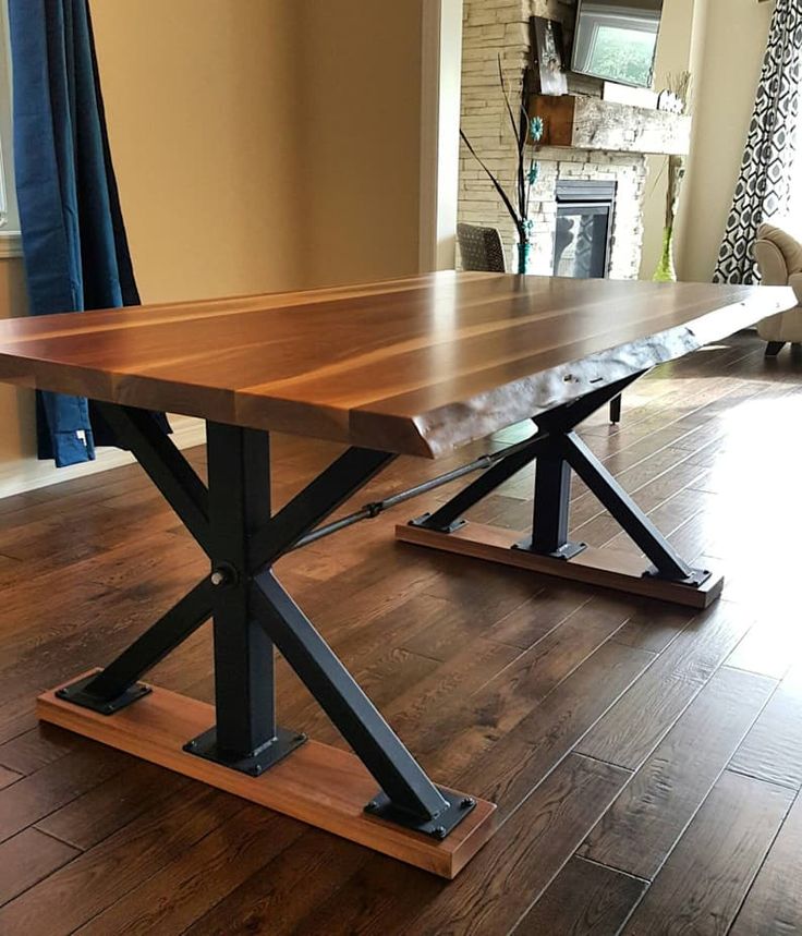 a wooden table sitting on top of a hard wood floor