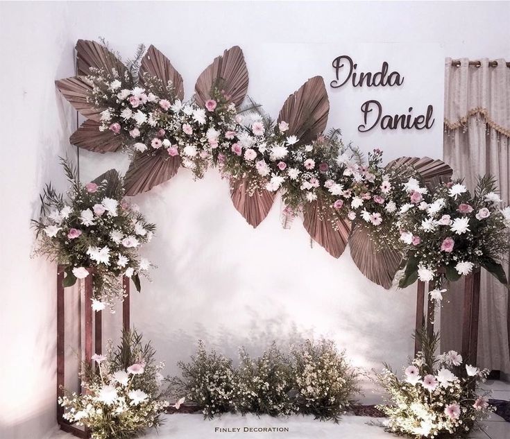 an arch decorated with pink and white flowers