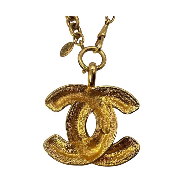 We are offering this rare Chanel Vintage Quilted CC Pendant Necklace. From the 1970 collection by Gabrielle 'Coco' Chanel, this piece is finely crafted of gold-tone hardware and features a lengthy necklace with the classic 'CC' logo pendant in a quilt-engraved appearance. Luxury Collectible Medallion Necklace, Formal Gold Chain Necklace With Logo Charm, Luxury Gold-tone Jewelry With Logo Charm, Gold-tone Necklace With Logo Charm For Formal Events, Formal Gold-tone Necklace With Logo Charm, Vintage Gold-tone Necklace With Logo Charm, Luxury Gold-plated Jewelry With Gold-tone Logo, Designer Gold-tone Brass Jewelry, Designer Yellow Gold Jewelry With Logo