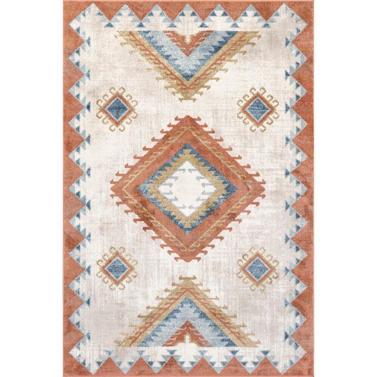 an orange, white and blue rug with diamond shapes on the bottom half of it