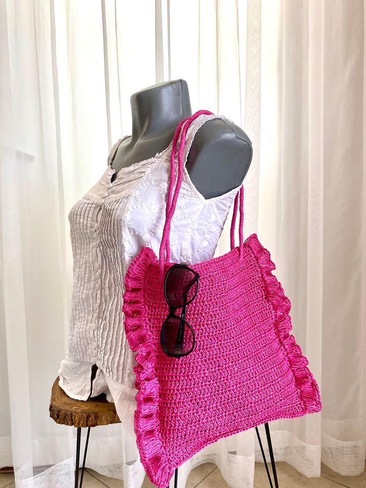 Comfort and style, boheme chic boho bag. Soft and casual. This tote bag is very practical and comfortable for your regular shopping or just carry your essentials.   If you want an other color, you can write me a message. Pink lovers are here. This wonderful bag is the most beautiful shade of pink. It is crocheted from natural raffia. You can use this bag with wonderful frills on both sides with every outfit. It is light.  Complete your elegance with straw bags, which are indispensable for the summer months. It adds a different style to even the simplest outfit.  It's a beautiful and useful gift. For mom, for sister, for bestie or for neighbor gift. The width of the bag is 28 cm (11 inch) with ruffles 34 cm (13.5 inch) Height 30 cm (11.5 inch)  Shoulder straps 62 cm (24.5 inch)  You can sen Bohemian Summer Tote Bag, Pink Crochet Rectangular Beach Bag, Pink Summer Crochet Bag, Casual Crochet Bag For Summer, Rectangular Pink Crochet Beach Bag, Spring Bohemian Bags, Pink Crochet Beach Bag For Everyday Use, Pink Crochet Bag For Beach, Pink Crochet Bag For The Beach