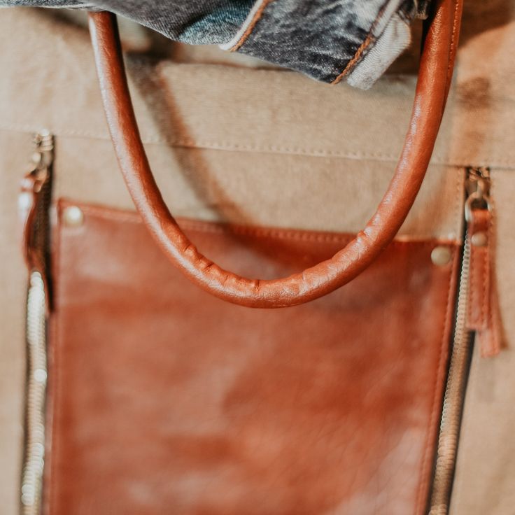 This classic tote was made to be effortlessly versatile. Bring both fashion and function to your everyday look. Color: Tan, Brown Size: 13' W x 18' H, 5" Handle Drop And Removable 24" Adjustable Strap Material: Up-Cycled Canvas, faux leather Origin: Imported On-the-go Satchel Bag With Leather Trim, Trendy Leather Bag With Zipper Closure, Chic Satchel With Zipper Closure For On-the-go, Versatile Satchel With Leather Handles For On-the-go, Everyday Leather Satchel With Detachable Handle, Leather Satchel With Detachable Handle For Everyday, Everyday Canvas Hobo Bag With Zipper, Everyday Canvas Hobo Bag With Zipper Closure, Trendy Weekender Shoulder Bag With Zipper