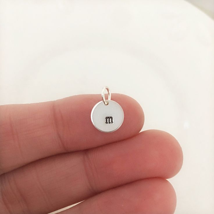 "A simple round sterling silver charm that you can add to your current necklace or charm bracelet. This is a 1/4\" charm and is 1mm thick. This charm matches the running necklaces and small initial necklace that I have in my shop. Customize it with a new race, initial, symbol, or name. To continue shopping http://justjaynes.etsy.com To preview new jewelry, \"Like\" me on Facebook: http://www.facebook.com/JustJaynes" Everyday Tiny Initial Pendant Charm Necklace, Simple Tiny Initial Pendant Charm Necklaces, Simple Tiny Initial Pendant Charm Necklace, Dainty Personalized Initial Pendant Charms, Personalized Dainty Initial Pendant Charms, Simple Personalized Pendant Charm Necklace, Minimalist Round Charms For Gifts, Minimalist Round Gift Charms, Personalized Small Charms For Gifts