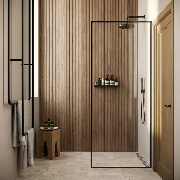 a bathroom with wooden walls and flooring next to a walk - in shower stall