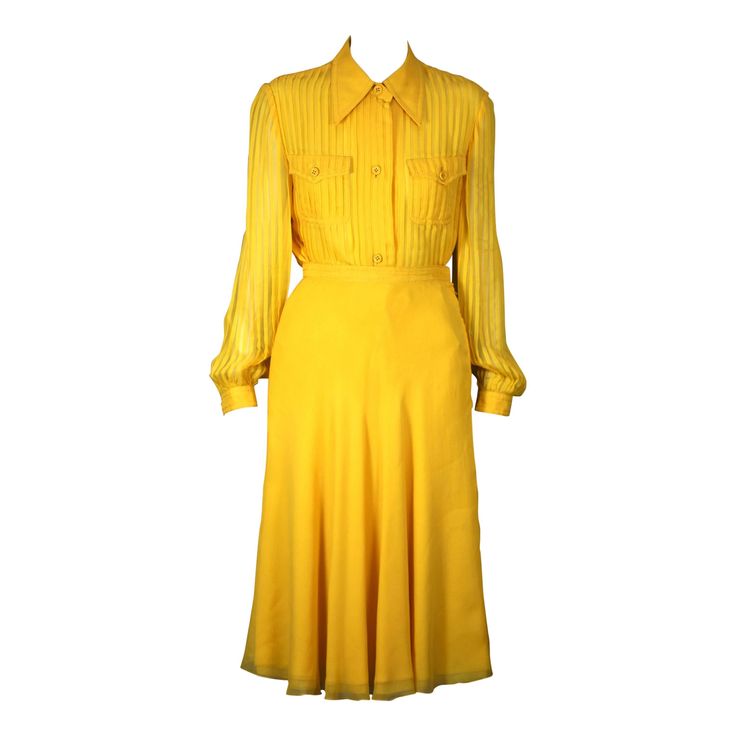 Galanos' Charming Chrome Yellow silk chiffon set with pin tucked shirt and 5 ply chiffon bias cut skirt. Blouse is completely pin tucked with 2 chest pockets and heavy silk top stitching. The top stitching is also repeated on the waist band of the skirt. Simple bias A line skirt with 5!!! layers of picot edged silk chiffon. Galanos quality is legendary and his customers felt the quality when they purchased his garments. Elegant ensemble, beautifully crafted and finished throughout. 1970's USA. S Suits Outfits, Skirt Blouse, Bias Cut Skirt, Blouse Skirt, Yellow Silk, Vintage Suits, Vintage Couture, Chiffon Skirt, Silk Chiffon