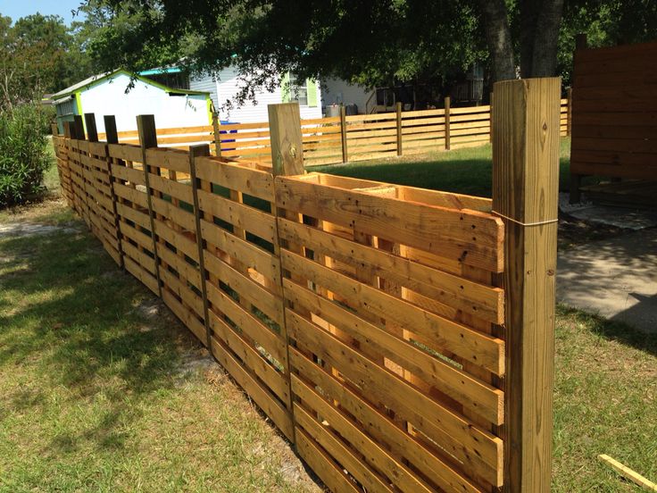 a wooden fence in the middle of a yard