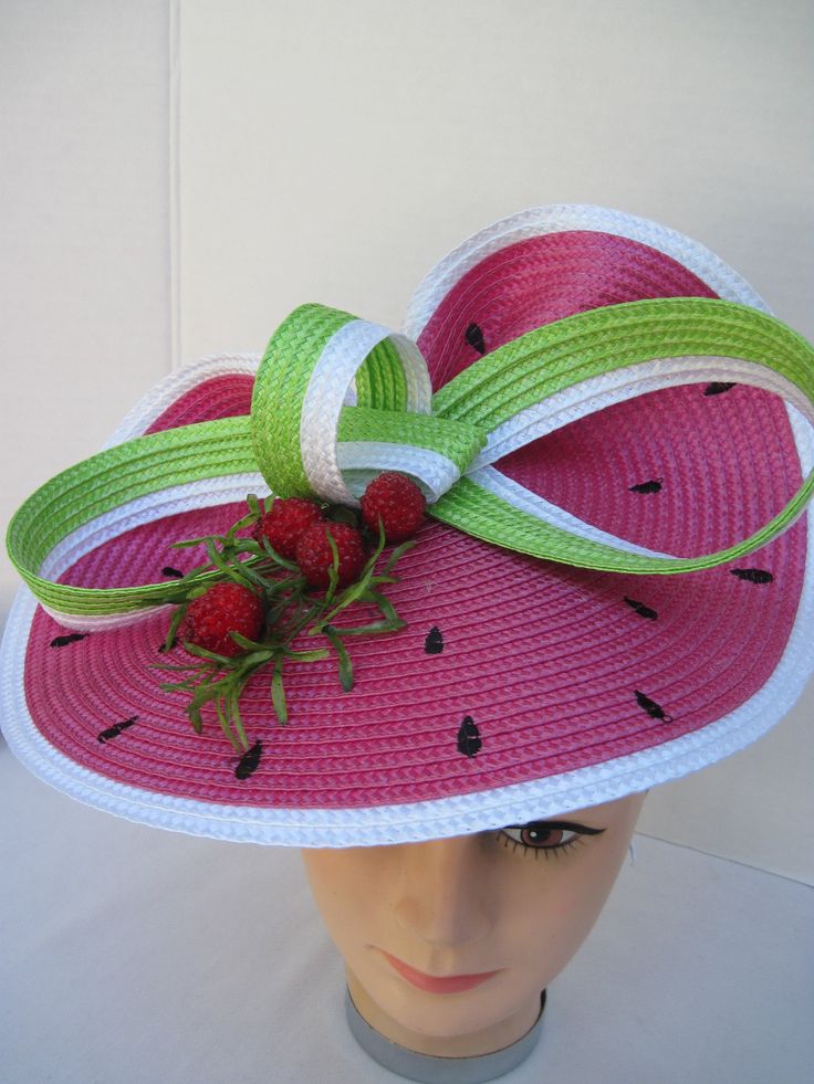 "* This design features the watermelon braiding as the hat foundation folded into design loops complemented by red raspberries and summer greens. * The hat form is about 12\" folded in back and tilted in a sophisticated design. * It is light weight, balanced and comfortable to wear year round. * Designed on a satin covered metal headband, it fits just about any head size and when viewed from any direction it looks complete, striking and eye catching. * Wear it throughout the year for special eve Whimsical Adjustable Straw Hat For Summer, Summer Whimsical Hat With Curved Brim, Whimsical Summer Hat With Curved Brim, Green Summer Boater Hat With Flat Brim, Green Boater Hat With Flat Brim For Summer, Whimsical Adjustable Summer Hats, Green Flat Brim Boater Hat For Summer, Fun Red Hat For Spring, Green Adjustable Hat Bands For Kentucky Derby