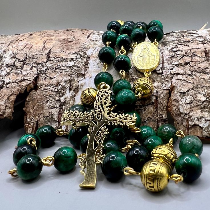 8mm Beads 75cm diameter  Handmade in Scotland - Green Tigers Eye Gold Catholic Rosary Beads Virgin Mary Miraculous Medal Tree of life Celtic This Handmade in Scotland - Green Tiger's Eye Gold Catholic Rosary Beads is a testament to the intersection of craftsmanship and spirituality. Meticulously crafted in Scotland, each bead is carefully selected for its unique green tiger's eye properties, radiating a rich blend of green and gold tones. The choice of Green Tiger's Eye infuses the rosary with a Polished Round Beads Rosary For Jewelry Making, Spiritual Rosary With Spacer Beads, Spiritual Rosary With Large Beads As Gift, Spiritual Round Beads Rosary For Jewelry Making, Gold Rosary With 8mm Beads For Healing, Polished Round Beads Rosary As Gift, Round Polished Bead Rosary As Gift, Gift Oval Beads 8mm Gems And Cabochons, Handmade Green Rosary