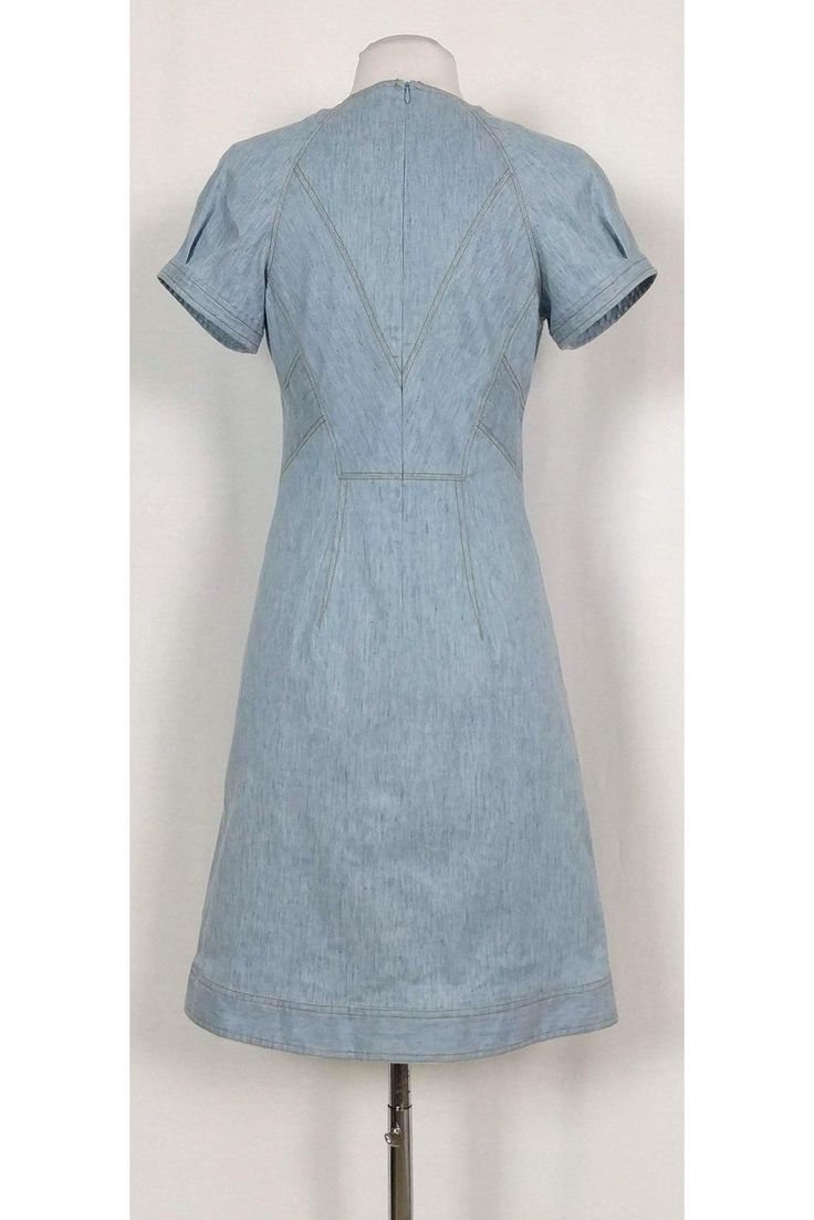 Versatile denim dress featuring a classic semi flared silhouette. The perfect dress to wear to a picnic at the park, pair it with chic sandals and a statement handbag. Size 4 Lined, cotton & elastane blend V-neckline Short sleeves Unlined Flared silhouette Mustard top stitching Above knee Bust 34" Waist 28" Shoulder to hem 37" Chic Mid-length Cotton Denim Dress, Classic Summer Denim Dress, Classic Fitted Denim Dress, Classic Denim Dress For Workwear In Spring, Classic Spring Denim Dress For Work, Classic Spring Denim Cotton Dress, Classic Cotton Denim Dress For Spring, Spring Denim Blue Workwear Denim Dress, Classic Knee-length Spring Denim Dress