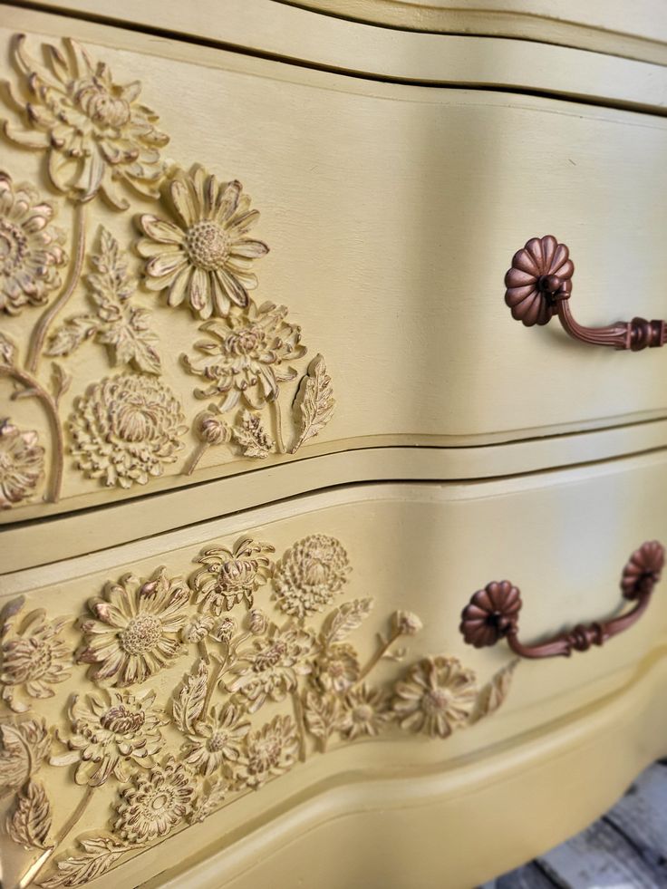 an antique dresser with flowers painted on it