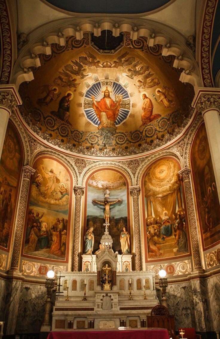 the interior of a church with paintings on the walls