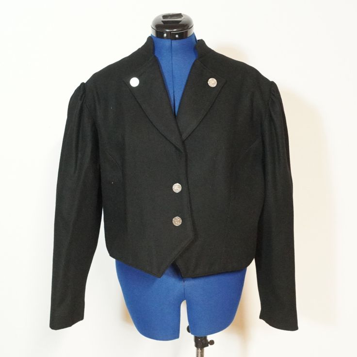 Very nice spencer jacket in black with wide club sleeves and a beautiful collar. It fastens at the front with metal buttons. The jacket is worn but in very good condition. The size is about 46/L Here are the measurements:  Chest width: 116cm  Waist size: 108cm  Length: 49cm  Sleeve length: 58cm Classic Formal Cropped Jacket With Button Cuffs, Vintage Black Outerwear With Stand Collar, Classic Cropped Jacket With Button Cuffs For Formal Occasions, Classic Cropped Jacket For Winter Formal Events, Classic Winter Cropped Jacket For Formal Occasions, Classic Black Cropped Jacket For Formal Occasions, Black Cropped Jacket With Suit Collar For Formal Occasions, Black Outerwear With Suit Collar And Button Cuffs, Black Outerwear With Button Cuffs And Suit Collar