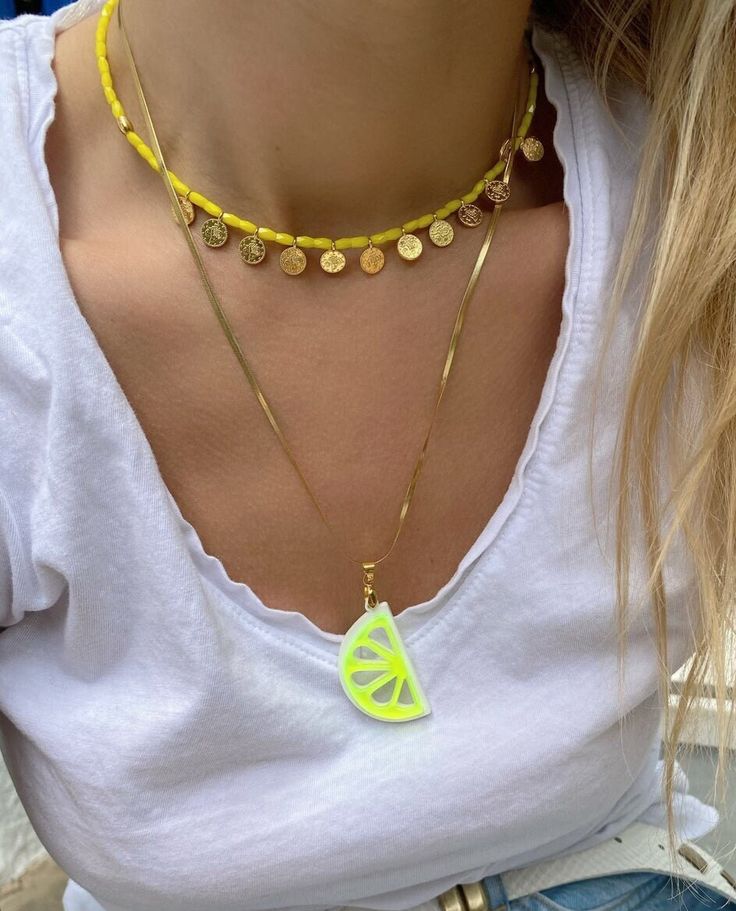 Introducing our handmade summer necklaces, perfect for adding a pop of color to any outfit! This set includes two unique pieces with a similar philosophy. The first necklace features sunny yellow beads and metal discs, while the longer necklace boasts a flat gold chain made from durable steel, with a stunning plexiglass melon pendant at the center. Wear them together for a layered look or separately to mix and match with your favorite accessories. These necklaces are exclusively available at Chr Neon Yellow Summer Beach Jewelry, Yellow Beaded Necklaces With Round Beads For Summer, Yellow Beaded Necklaces For Summer, Summer Yellow Beaded Necklaces, Yellow Necklaces With Colorful Beads For Summer, Yellow Beaded Necklaces With Letter Beads For Summer, Yellow Beaded Chain Necklaces For Summer, Yellow Round Bead Necklaces For Summer, Yellow Round Beads Necklace For Summer