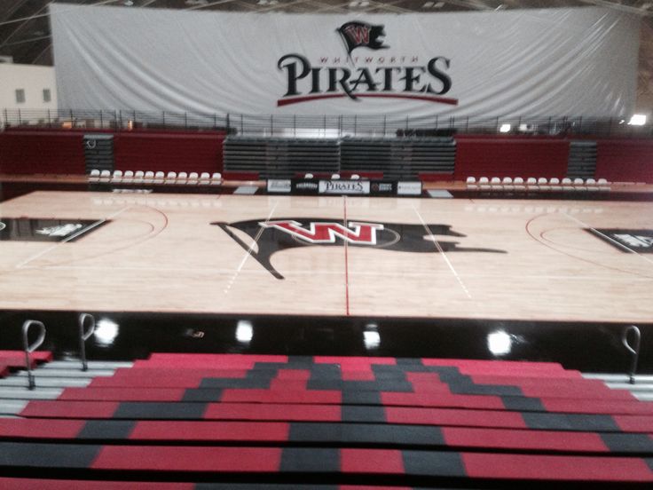 an empty basketball court with the words pirates on it in front of a large screen