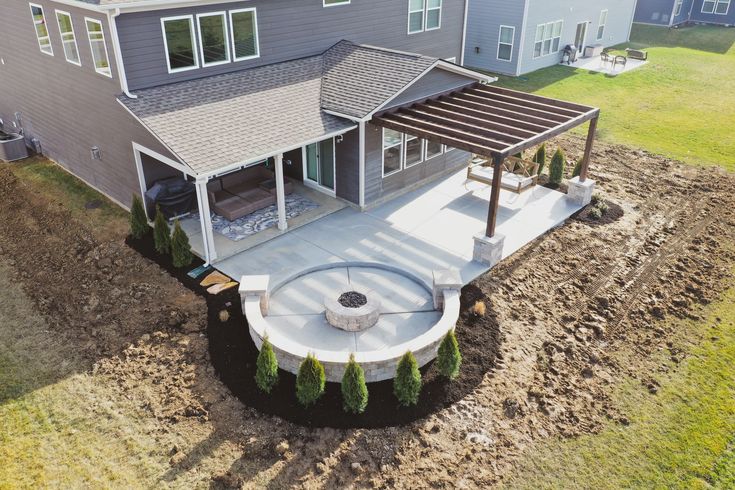 an aerial view of a house with a covered patio and hot tub in the yard