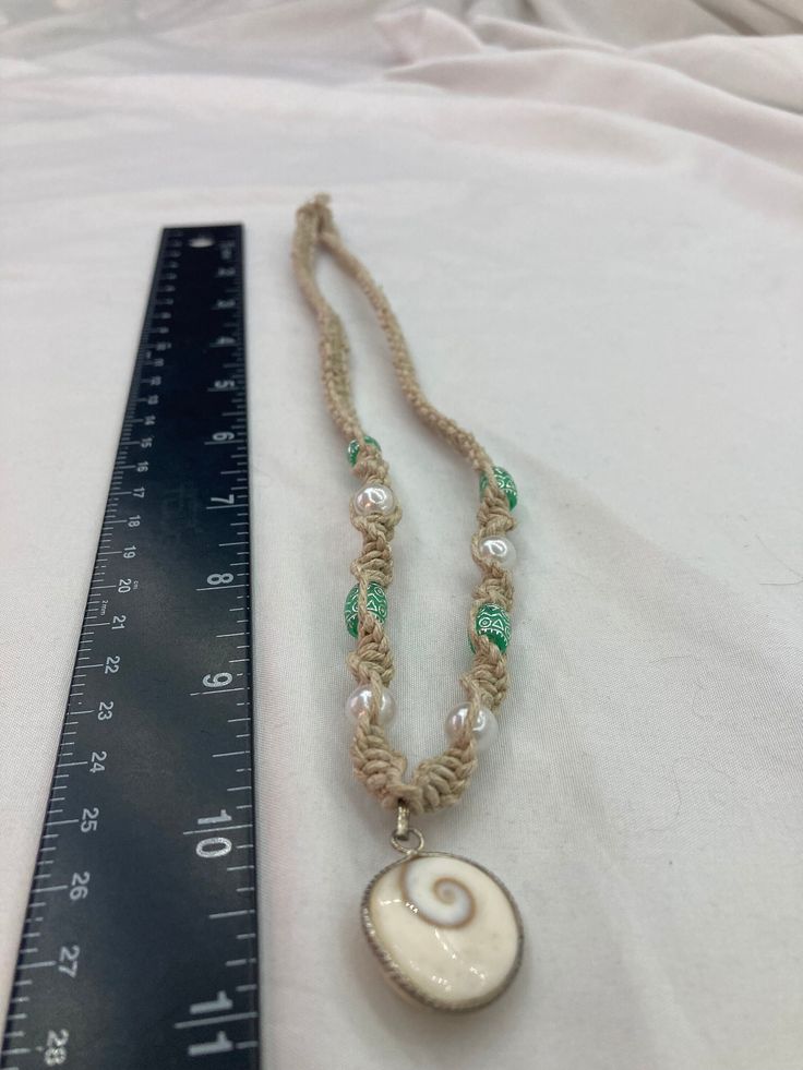 Handmade MD hemp tied beaded necklace 11 inches in length, with seafoam green ceramic beads, pearl beads, with a shell pendant. Green Ceramics, Pearl Shell, Shell Pendant, Beaded Necklaces, Ceramic Beads, Seafoam Green, Porcelain Ceramics, Sea Foam, Chain Styles