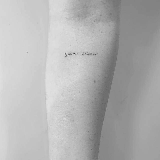 a woman's leg with the word you are in cursive writing on it