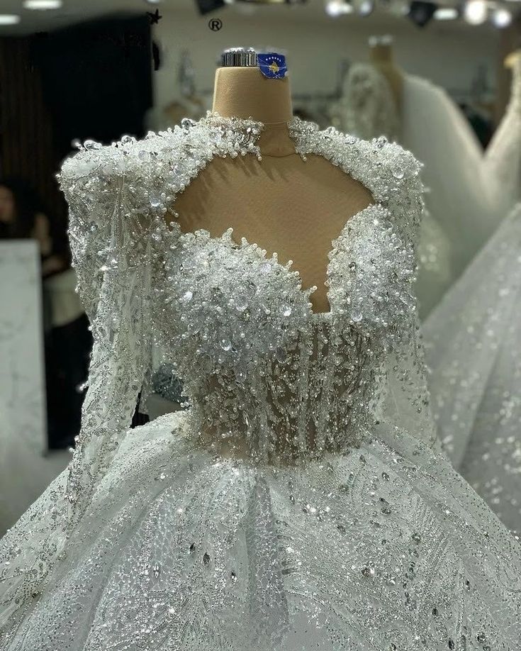 a dress on display in a store with other mannequins and dresses behind it