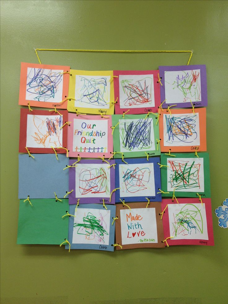 children's handprints are hung on the wall with clothes pins and string