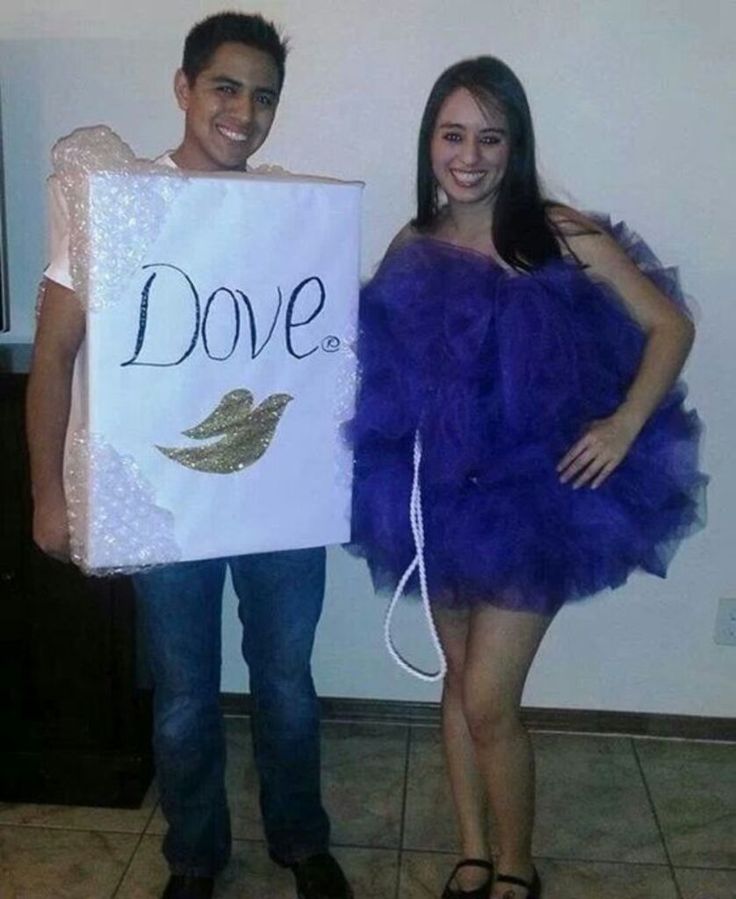 two people dressed up in costumes and holding a sign