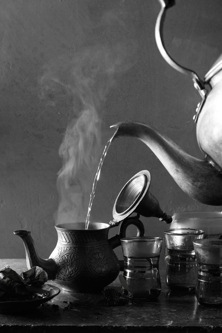 black and white photograph of tea pot pouring water